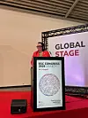 Taler bak en talerstol på en konferansescene med ESC Congress 2026-grafikk.
